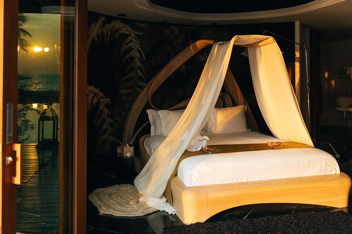 A unique suite with a hand-carved wooden bed