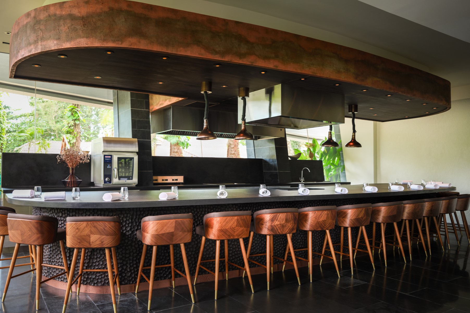 A beautiful 15-seat chef's table surrounding a cooking area